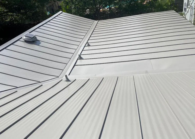 Solar attic fan installed on a metal roof for Roof Ventilation in Greene